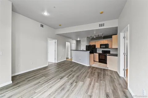 a view of a kitchen with white cabinets and refrigerator