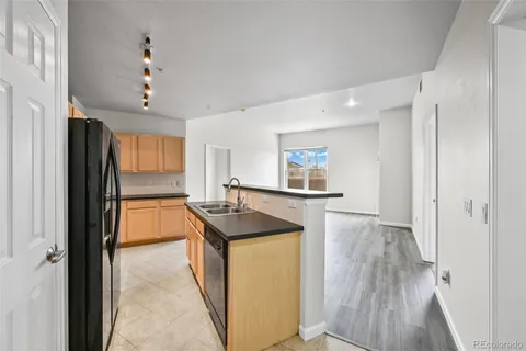 a kitchen with stainless steel appliances a stove a microwave a sink and cabinets