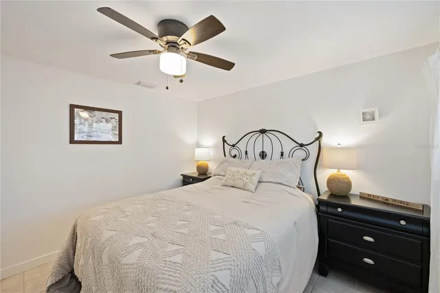 a bedroom with a bed and a ceiling fan