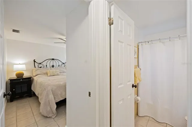 a bedroom with a bed and a mirror