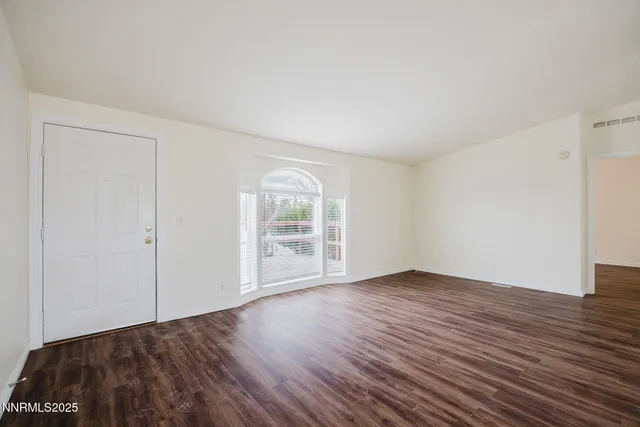 a view of a kitchen with wooden floor and a sink
