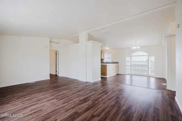 a kitchen with stainless steel appliances granite countertop a sink a stove and white cabinets