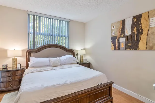 a bedroom with a bed and a painting on the wall