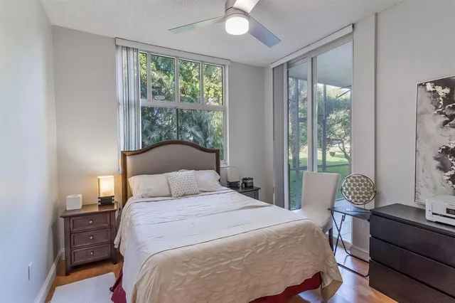 a bedroom with a bed and a large window
