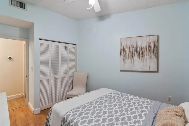 a bedroom with a bed and a painting on the wall