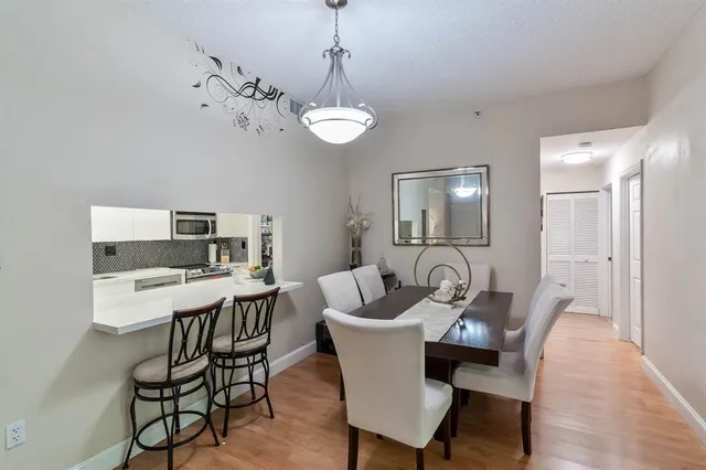 a view of a dining room with furniture wooden floor and a chandelier