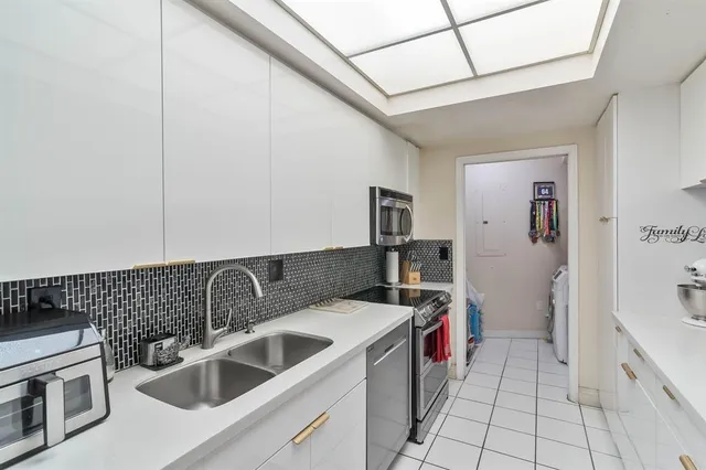 a kitchen that has a sink and a stove