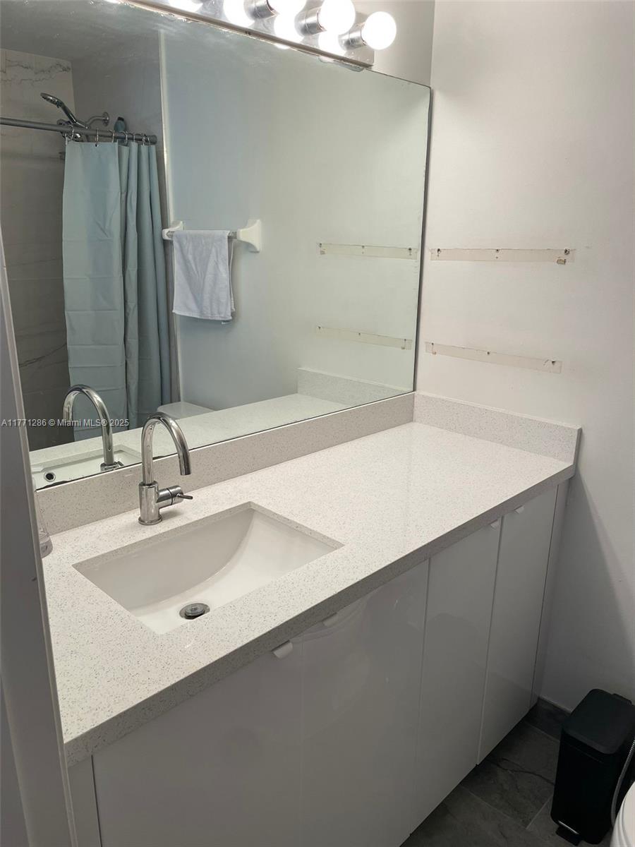 9 Whitehead Circle, Unit 9 Weston, FL 33326 - Photo 19 of 22 a bathroom with a sink and a mirror