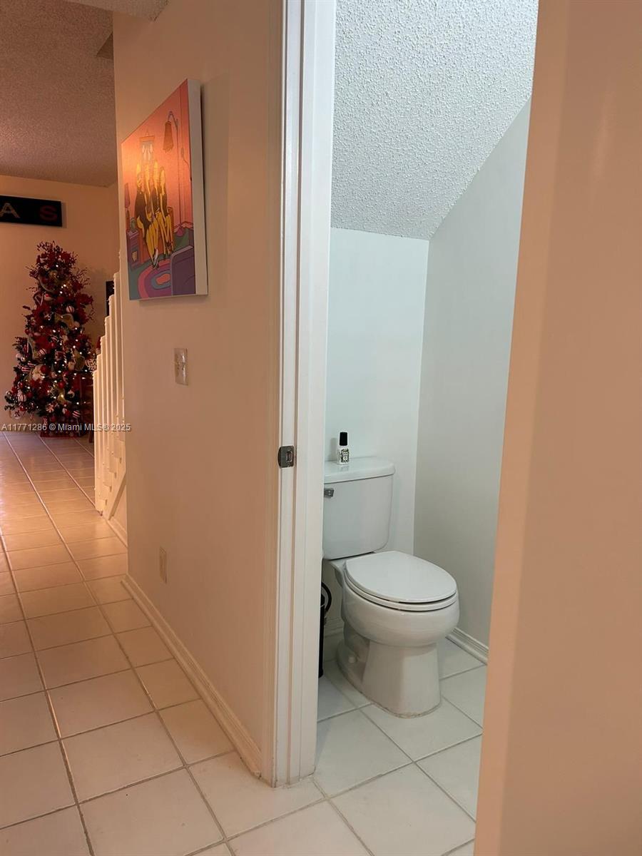 9 Whitehead Circle, Unit 9 Weston, FL 33326 - Photo 21 of 22 a white toilet sitting next to a white sink and vanity