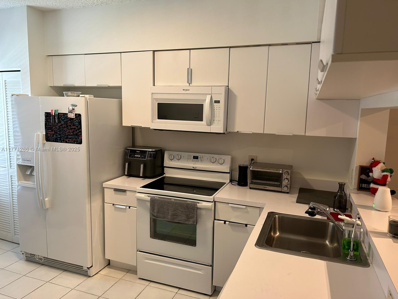 9 Whitehead Circle, Unit 9 Weston, FL 33326 - Photo 4 of 22 a kitchen with a stove and a microwave