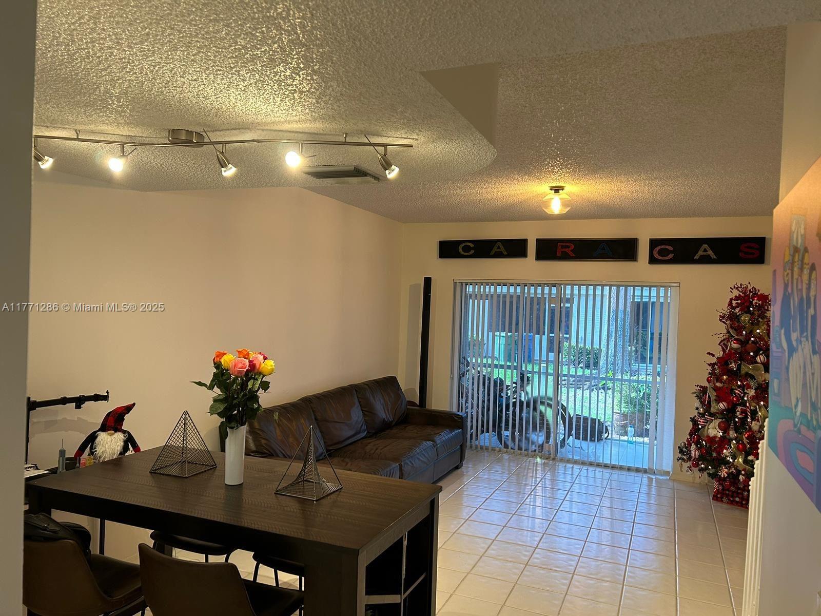 9 Whitehead Circle, Unit 9 Weston, FL 33326 - Photo 7 of 22 a workspace with furniture and flowers