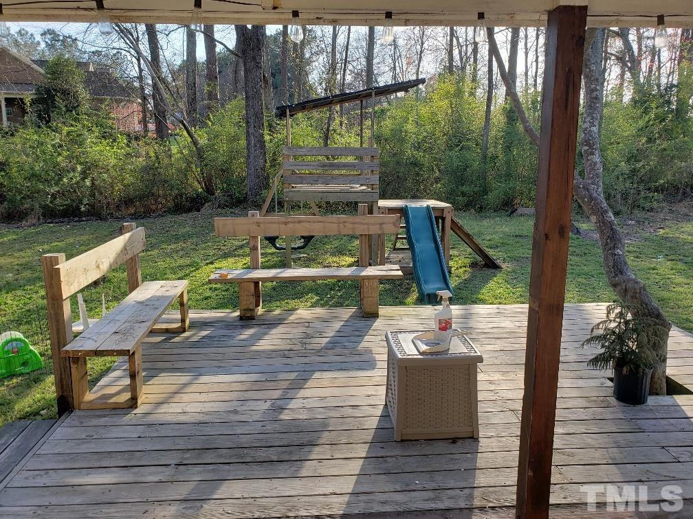198 Pope Lake Road Angier, NC 27501 - Photo 4 of 19 a view of a deck with couches table and chairs and wooden floor