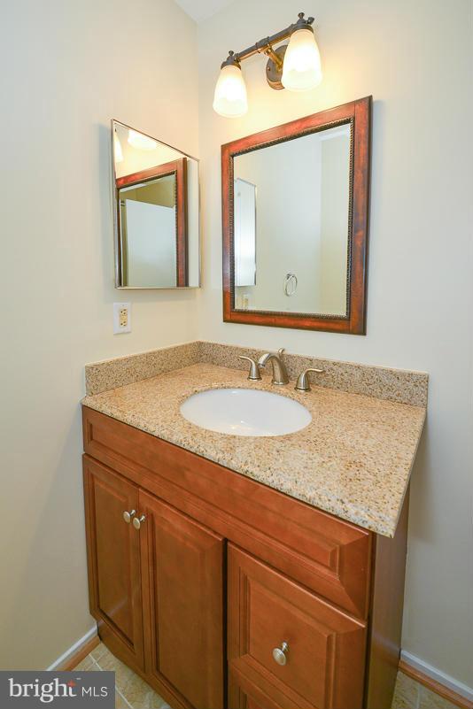 11743 Summerchase Circle, Unit B Reston, VA 20194 - Photo 14 of 24 a bathroom with a granite countertop sink and a mirror