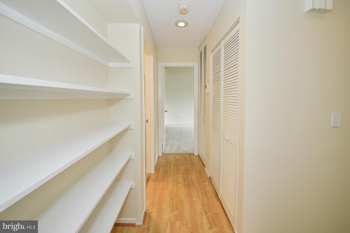 11743 Summerchase Circle, Unit B Reston, VA 20194 - Photo 19 of 24 a view of a hallway with wooden floor and a bathroom