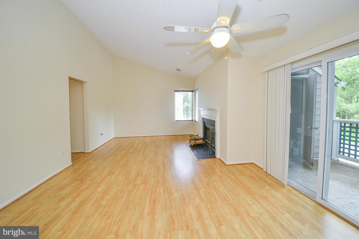 11743 Summerchase Circle, Unit B Reston, VA 20194 - Photo 3 of 24 a bedroom with a bed and a chandelier