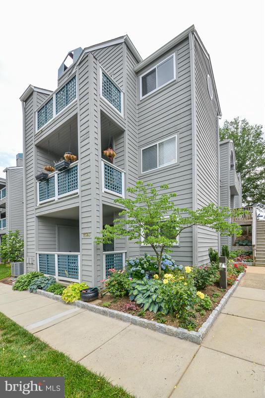 11743 Summerchase Circle, Unit B Reston, VA 20194 - Photo 22 of 24 a view of a house with a yard and plants