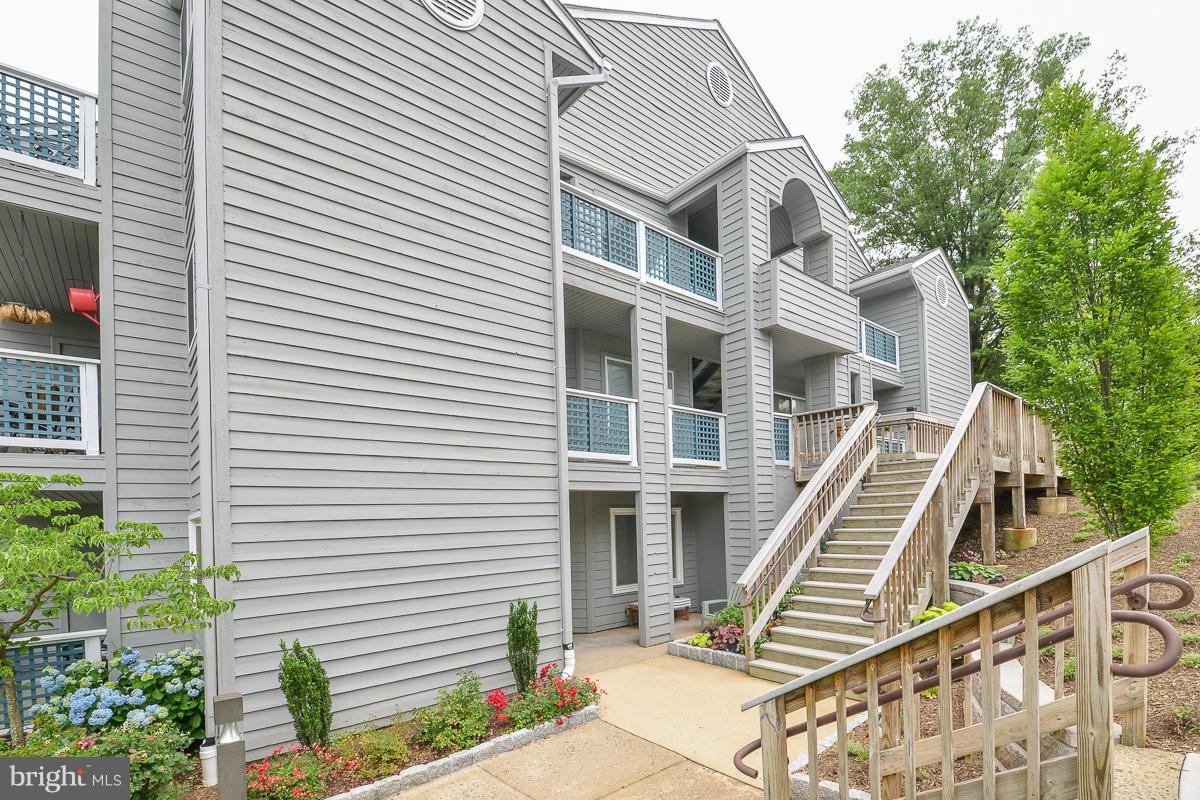 11743 Summerchase Circle, Unit B Reston, VA 20194 - Photo 23 of 24 a front view of a house with a garden