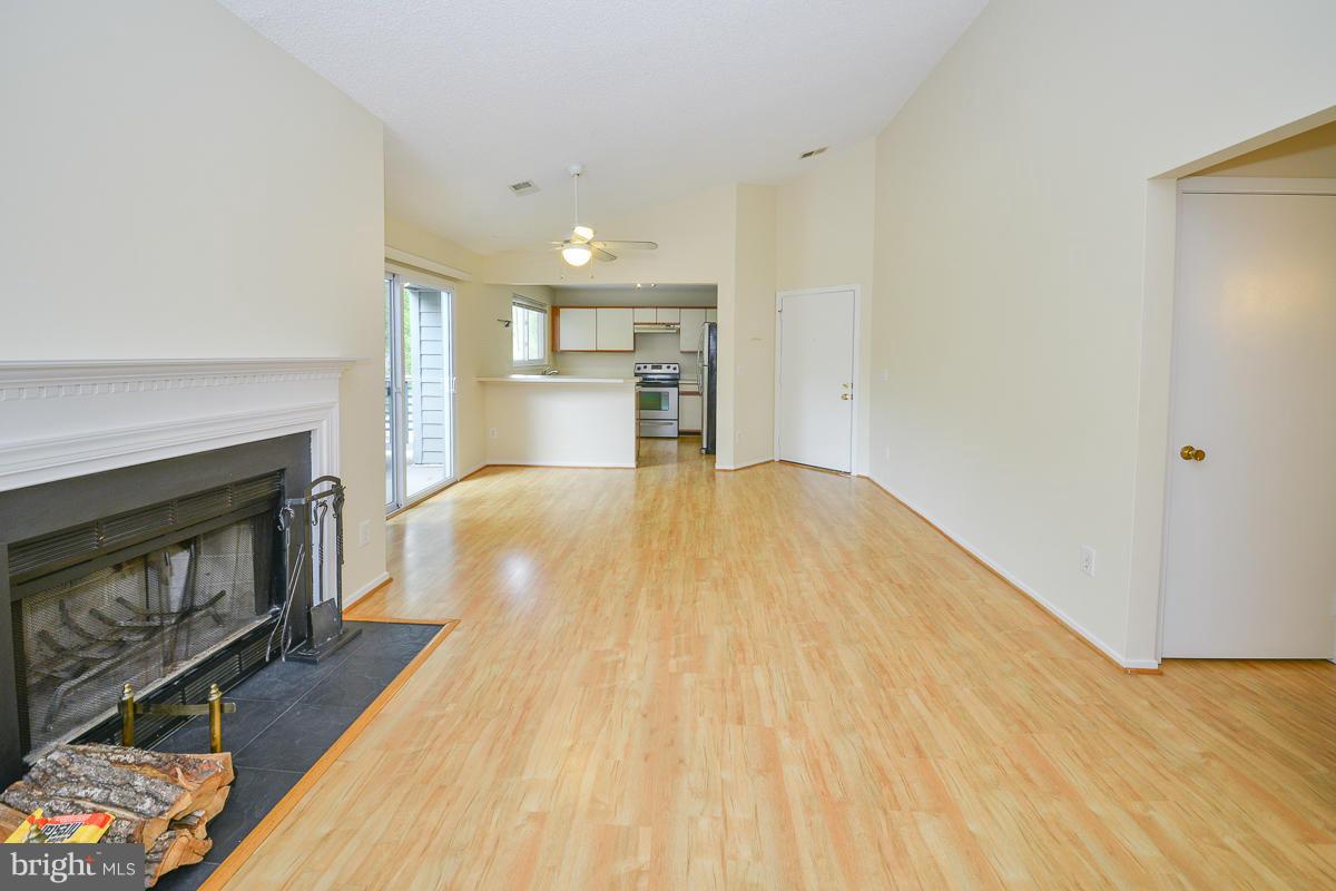 11743 Summerchase Circle, Unit B Reston, VA 20194 - Photo 5 of 24 a view of empty room with wooden floor and fireplace