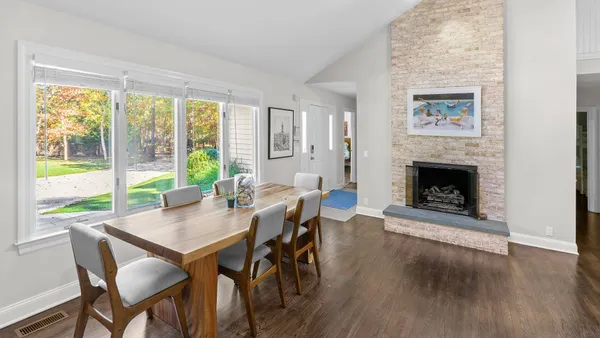 a view of a dining room with furniture window and wooden floor
