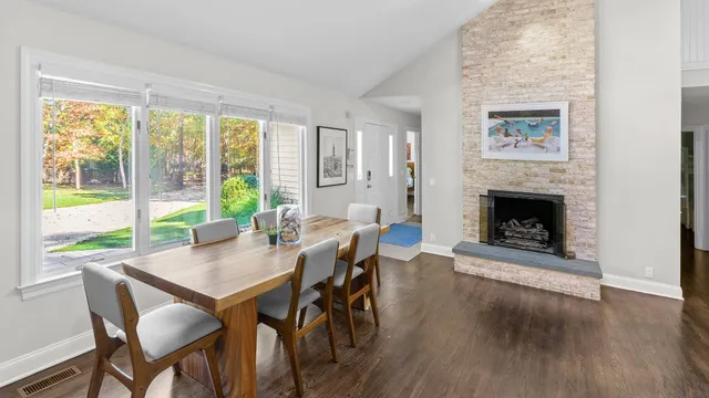 a view of a dining room with furniture window and wooden floor