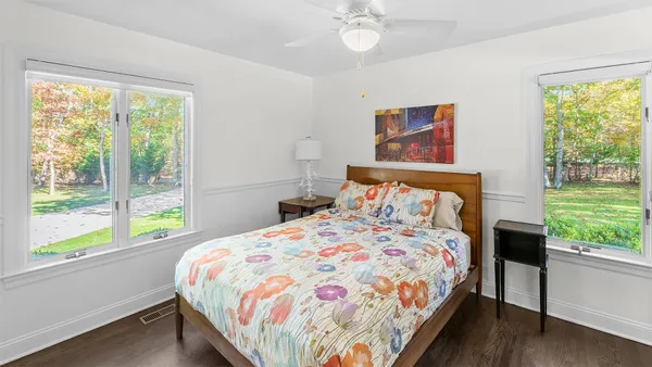 a bedroom with a bed and a large window