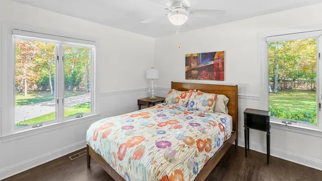 a bedroom with a bed and a large window