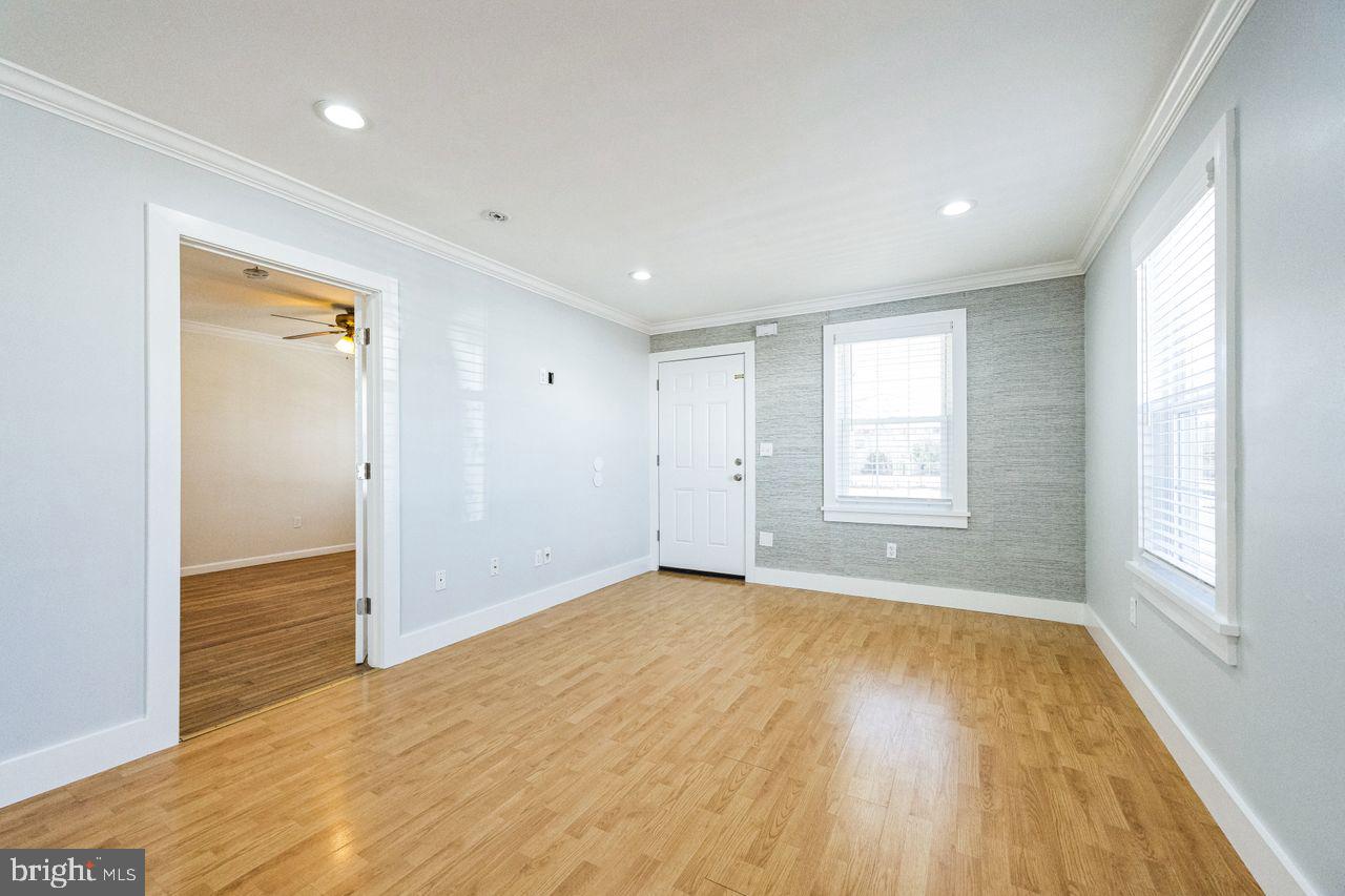 609 Cleveland Avenue Riverside, NJ 08075 - Photo 5 of 36 an empty room with wooden floor and windows