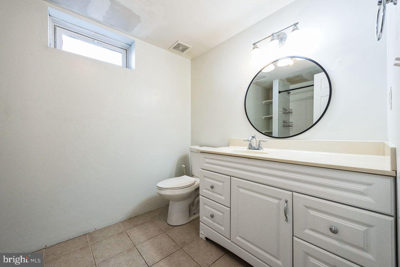 609 Cleveland Avenue Riverside, NJ 08075 - Photo 8 of 36 a bathroom with a toilet a sink and a mirror