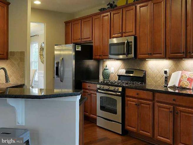 2643 St Marys View Road Accokeek, MD 20607 - Photo 3 of 20 a kitchen with stainless steel appliances granite countertop a stove a refrigerator and a microwave