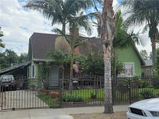 a backyard of a house with palm trees