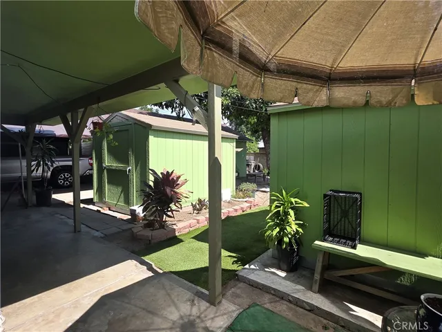 a view of a porch with furniture and next to a yard