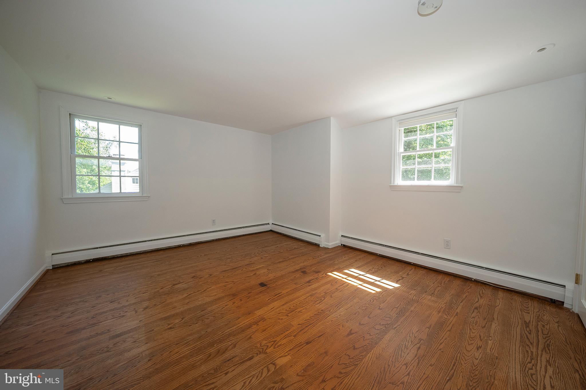 820 Milmar Road Newtown Square, PA 19073 - Photo 15 of 32 an empty room with wooden floor and windows