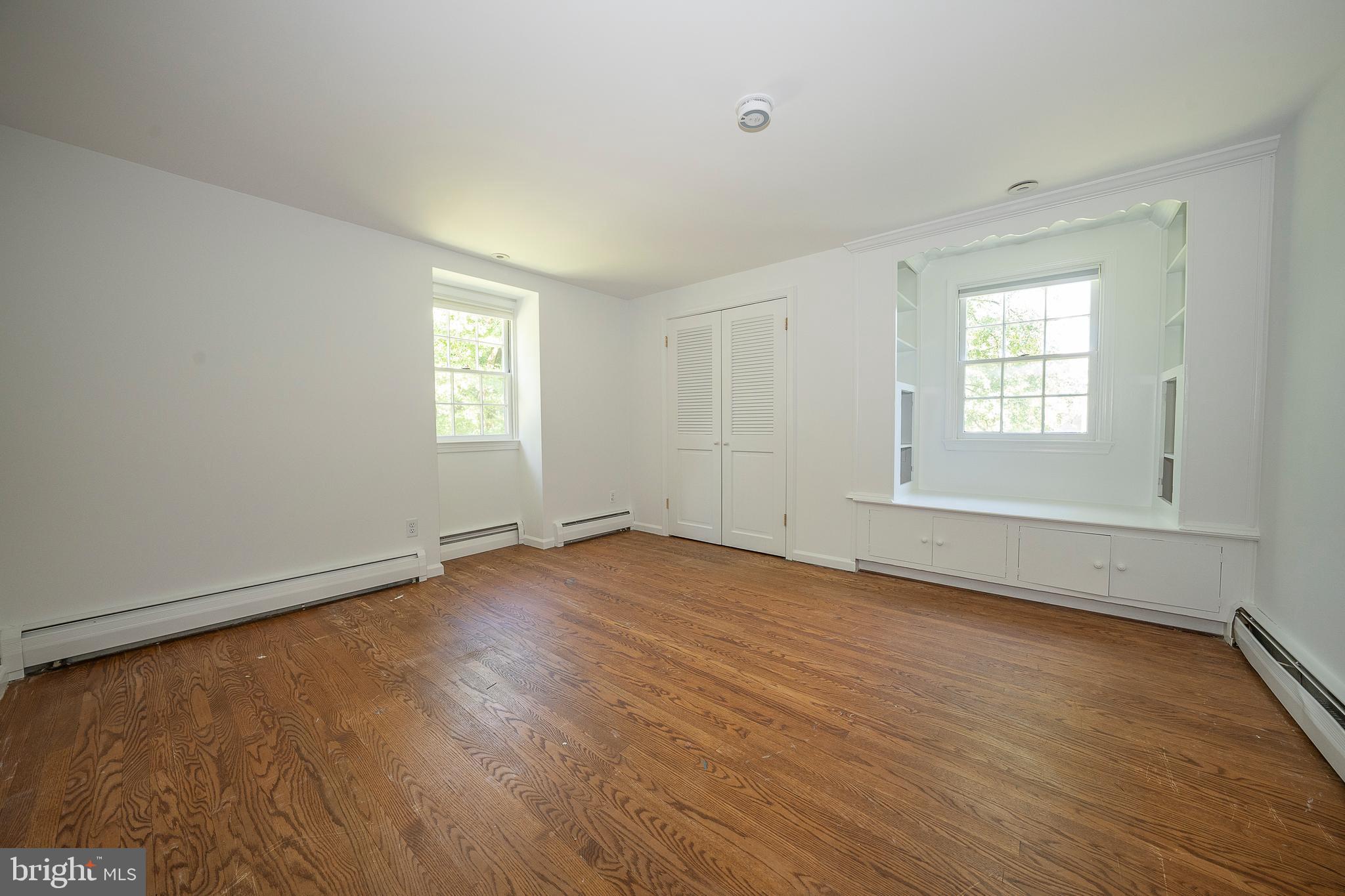 820 Milmar Road Newtown Square, PA 19073 - Photo 16 of 32 an empty room with wooden floor and window