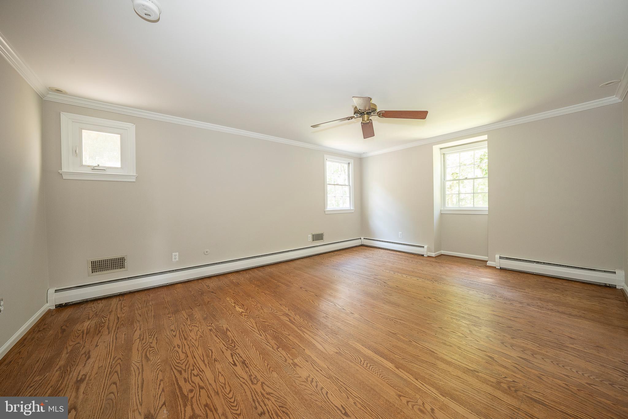 820 Milmar Road Newtown Square, PA 19073 - Photo 19 of 32 an empty room with wooden floor and windows