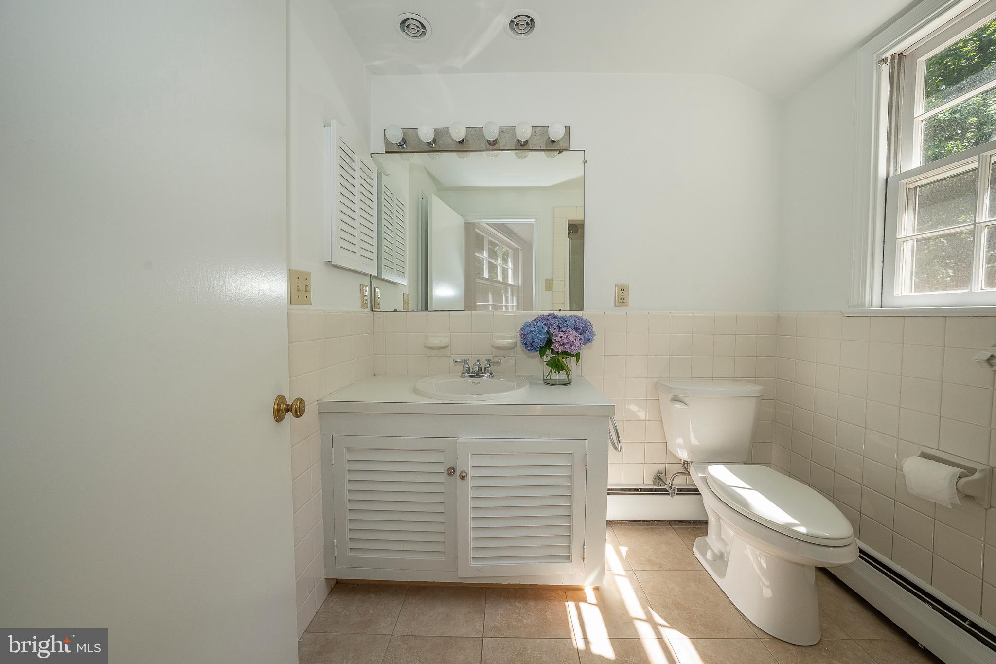 820 Milmar Road Newtown Square, PA 19073 - Photo 23 of 32 a bathroom with a sink vanity mirror and toilet