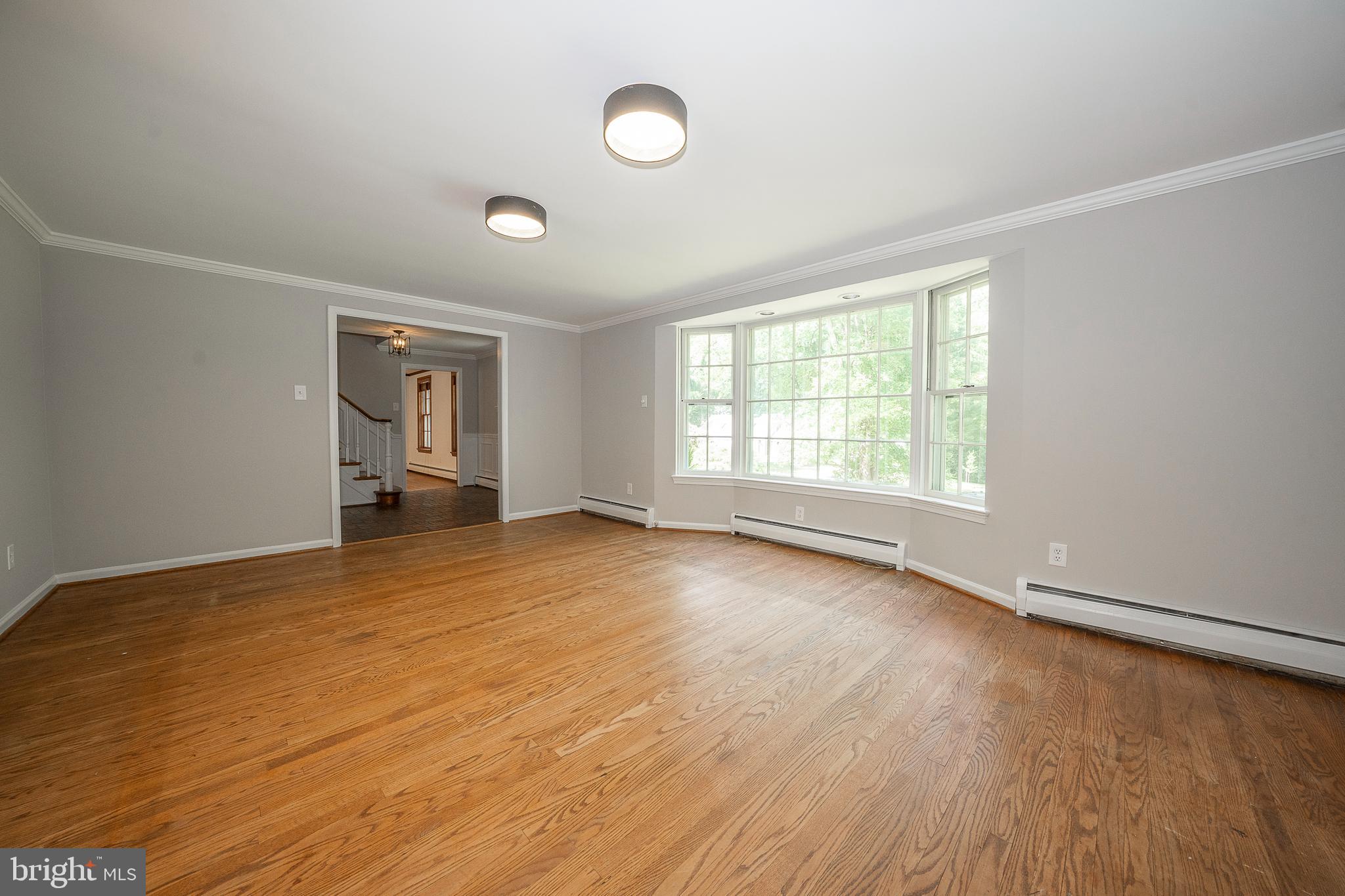 820 Milmar Road Newtown Square, PA 19073 - Photo 4 of 32 an empty room with wooden floor and windows