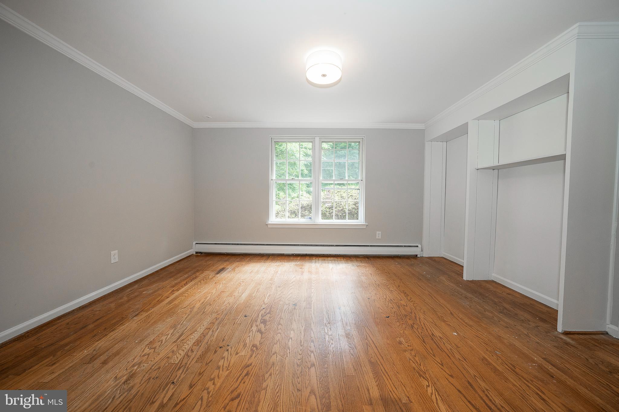 820 Milmar Road Newtown Square, PA 19073 - Photo 5 of 32 an empty room with wooden floor and windows