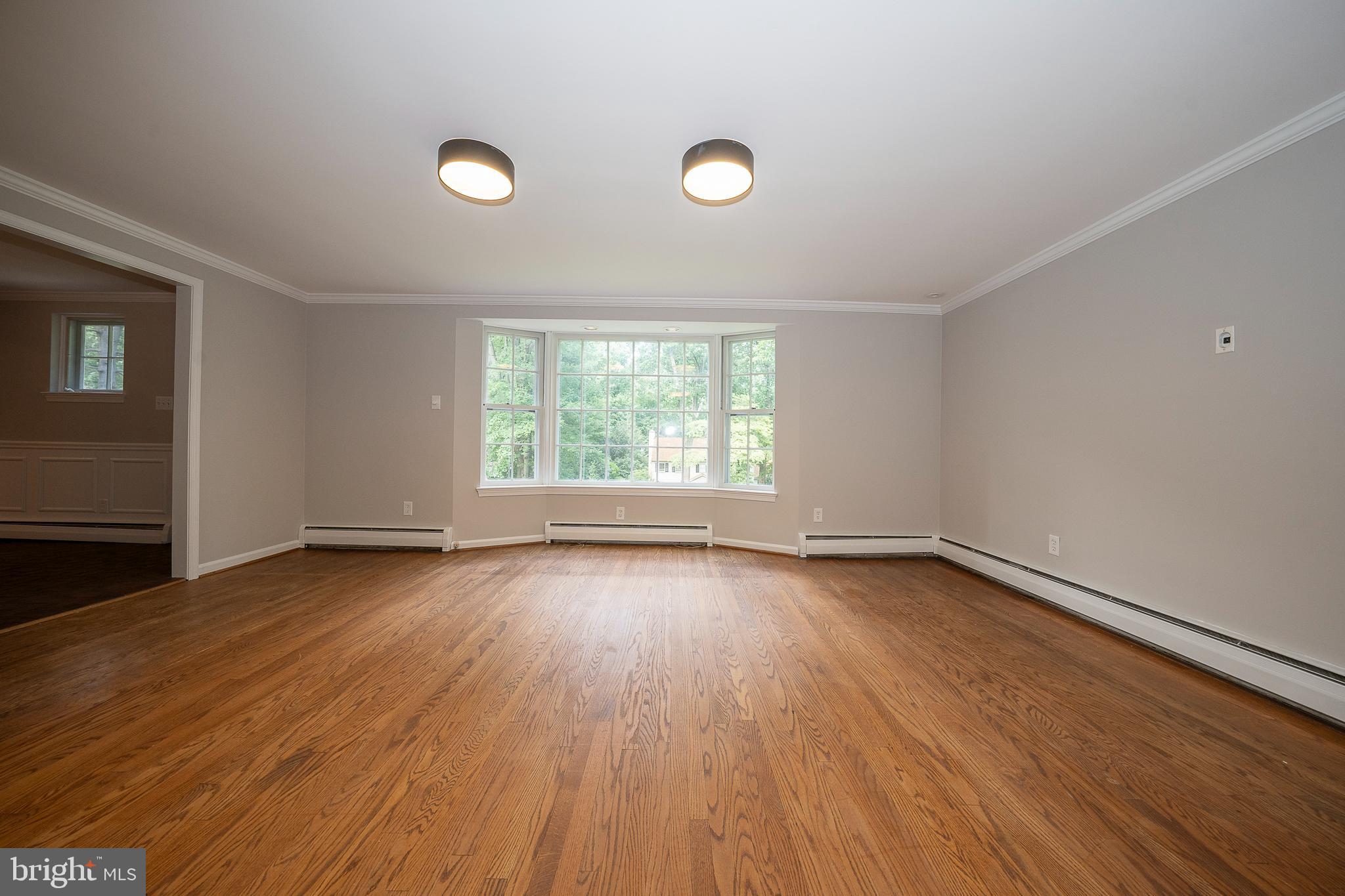 820 Milmar Road Newtown Square, PA 19073 - Photo 6 of 32 an empty room with wooden floor and windows