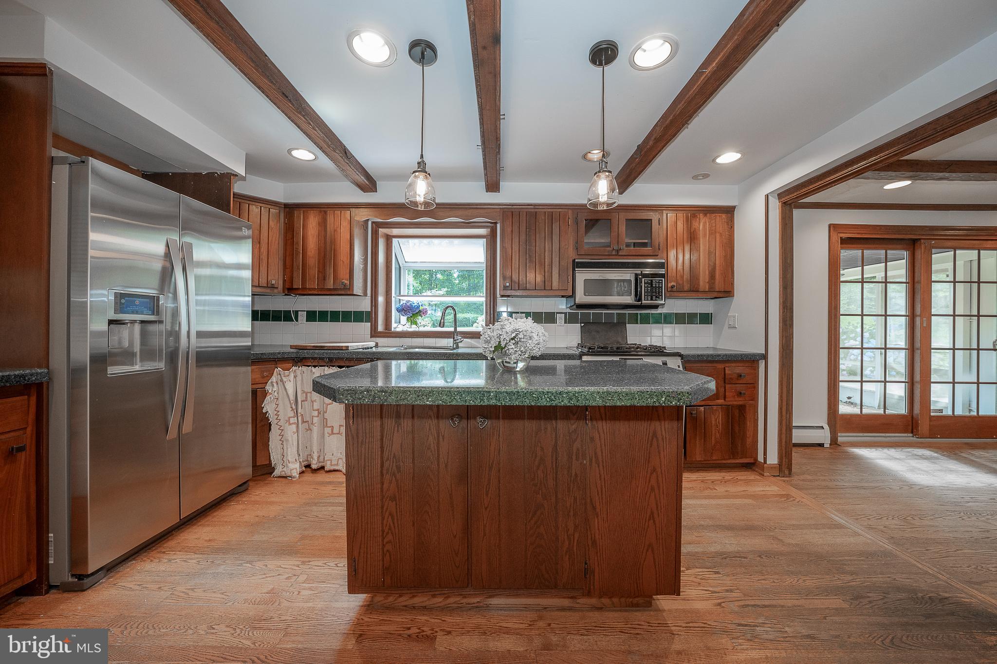820 Milmar Road Newtown Square, PA 19073 - Photo 9 of 32 a kitchen with stainless steel appliances granite countertop a refrigerator a sink a stove a microwave and island