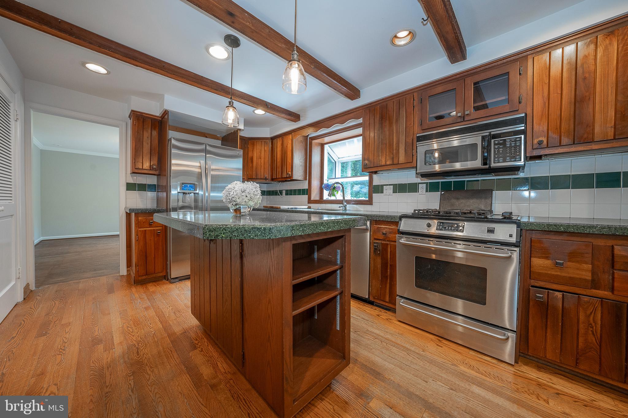 820 Milmar Road Newtown Square, PA 19073 - Photo 10 of 32 a kitchen with stainless steel appliances granite countertop a stove a sink and a microwave