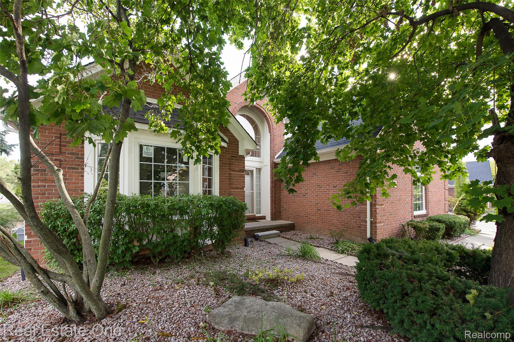 1013 Rochelle Park Drive Rochester, MI 48307 - Photo 2 of 74 Brick exterior featuring a gabled roof and bay window