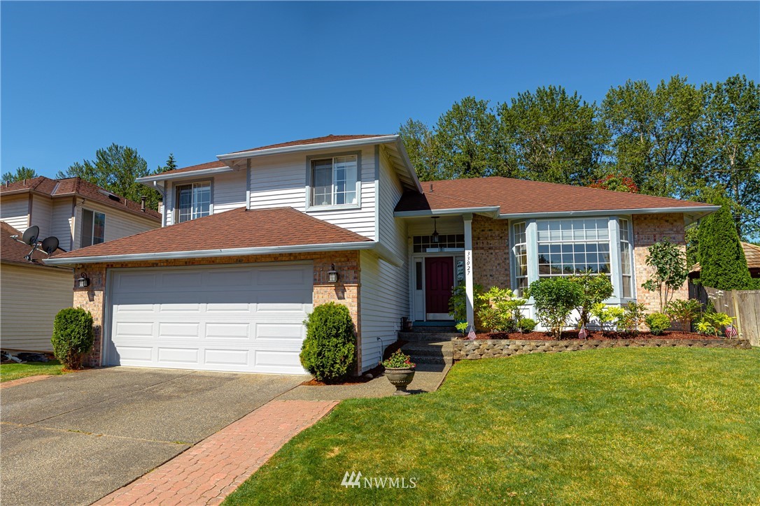 a front view of a house with a garden and porch
