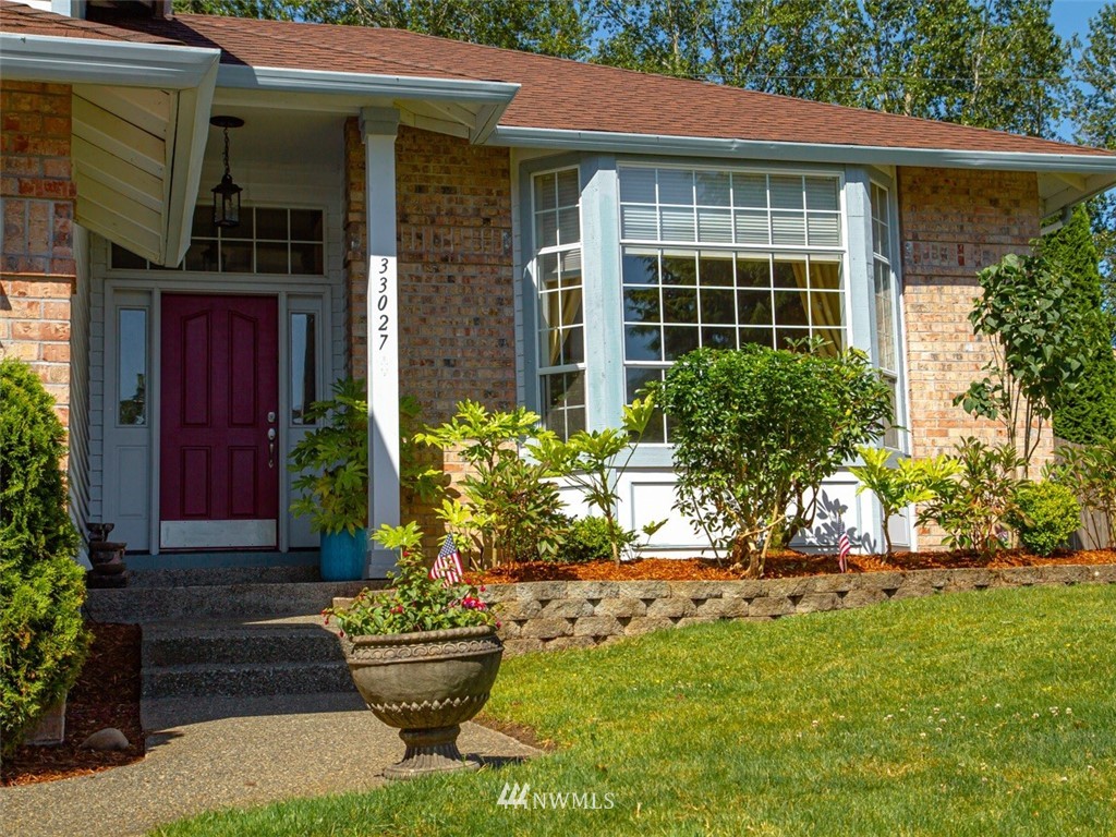 33027 20th Place Southwest Federal Way, WA 98023 - Photo 2 of 23 a front view of a house with a yard and fountain