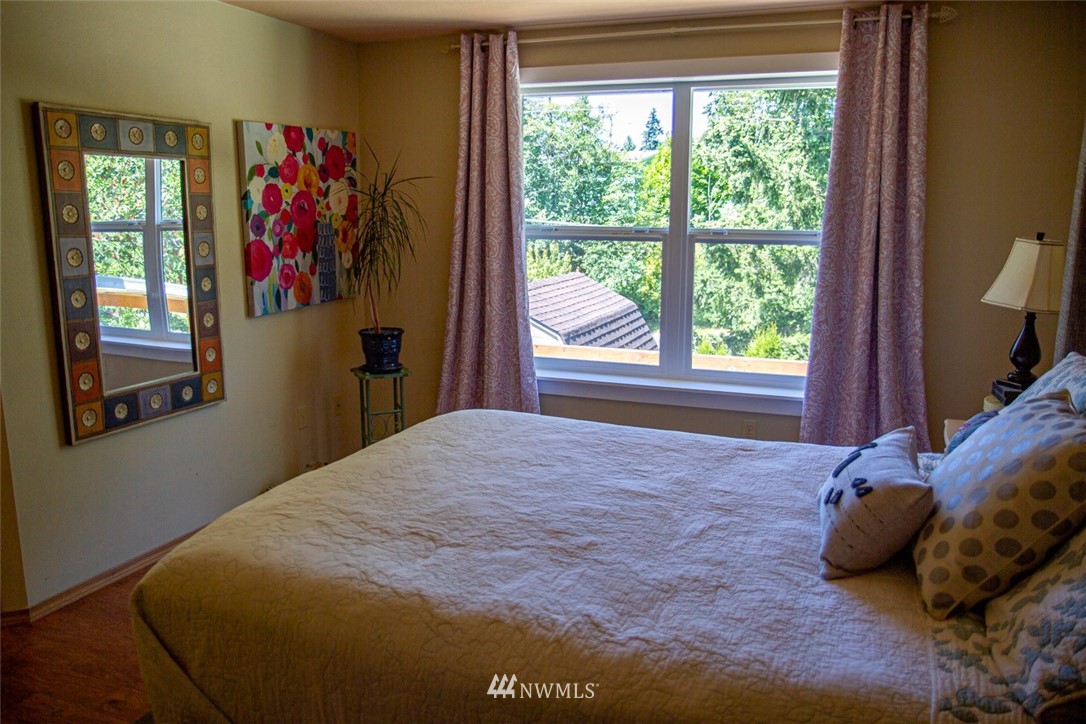 33027 20th Place Southwest Federal Way, WA 98023 - Photo 16 of 23 a bed sitting in a bedroom next to a window