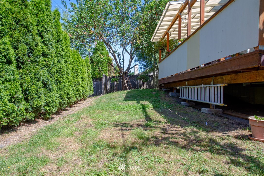 33027 20th Place Southwest Federal Way, WA 98023 - Photo 17 of 23 a view of backyard with wooden fence and large trees