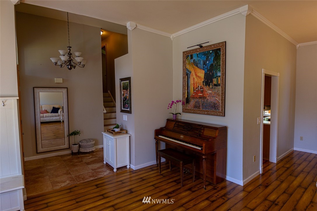 33027 20th Place Southwest Federal Way, WA 98023 - Photo 5 of 23 a view of a hallway with wooden floor and a livingroom