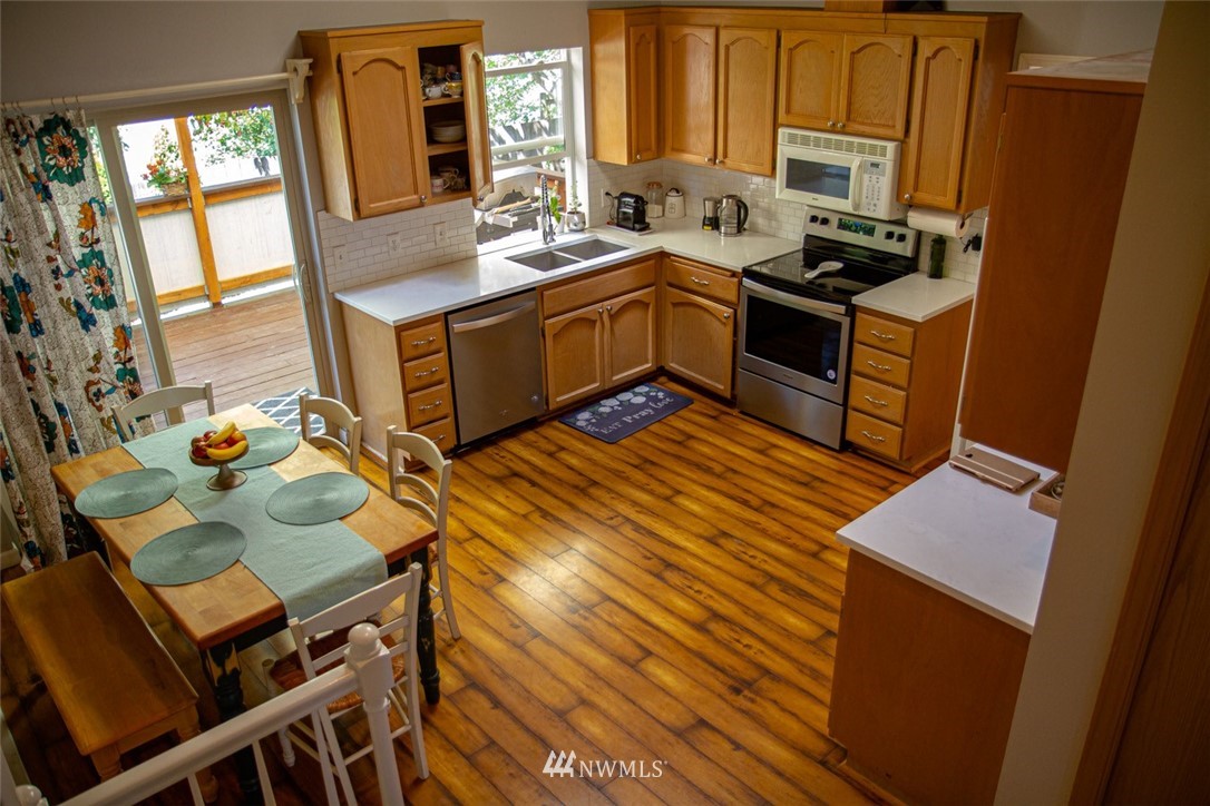 33027 20th Place Southwest Federal Way, WA 98023 - Photo 6 of 23 a kitchen with wooden cabinets and sink