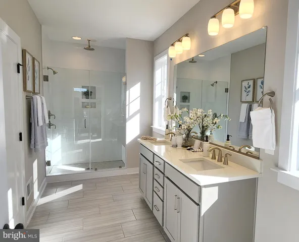 a bathroom with a double vanity sink mirror double and shower