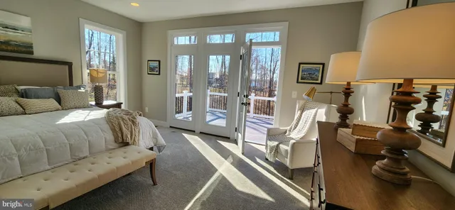 a bedroom with a bed and glass door