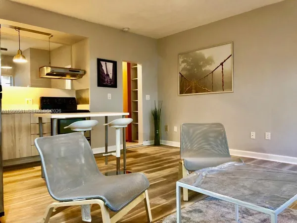a dining room with furniture and wooden floor